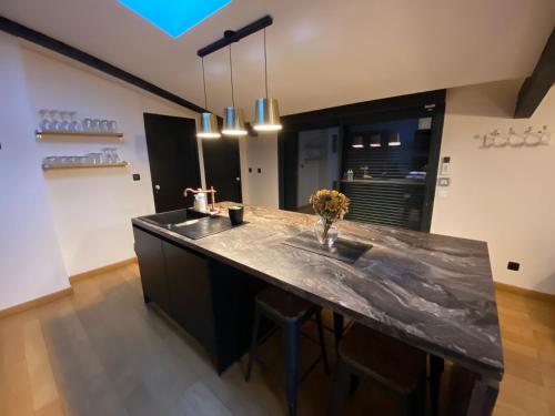 a kitchen with a counter with a sink at Au cœur de la Pinède de 1 à 4 personnes in Langlade