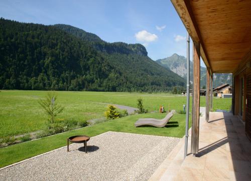 a patio with a view of a field and mountains at Haus Sonne & SPA in Bizau