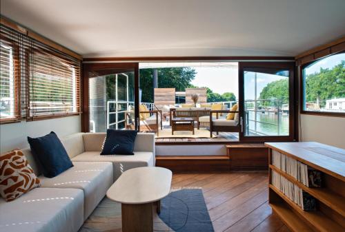 a living room with a couch and a table at Escale Sur Seine in Paris