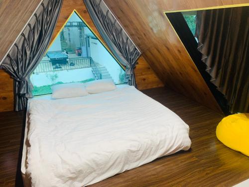 a bedroom with a white bed in a tent at Cloudy Home - Venuestay in Hanoi