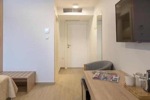 a room with a table and a television and a door at Šangulin Palace V in Biograd na Moru