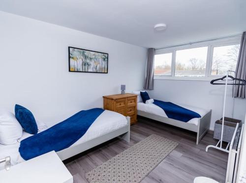 a bedroom with two beds and a window at The Wheelhouse, 3 bed sleeps 6, Parking and wi-fi in Washington