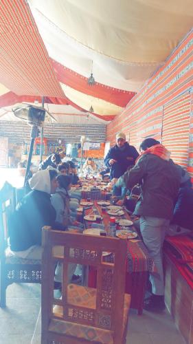 a group of people working at a table in a store at blueskyrum. in Wadi Rum