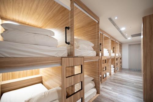 a group of bunk beds in a room at Lovestar Lakeside Hotel - Stars Building in Nanwan
