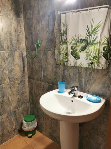 a bathroom with a sink and a mirror at Posada La Maza in Arnuero