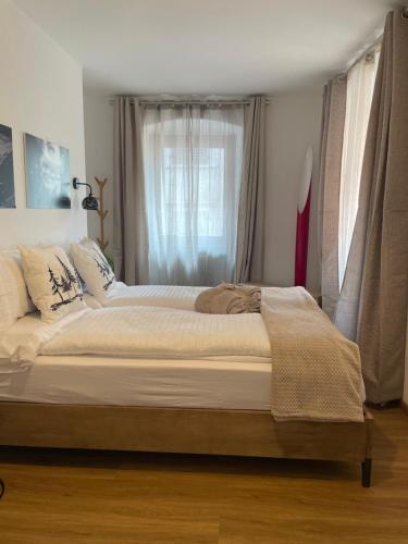 a large bed in a bedroom with a window at Ai Tre Garofani B&B in Trento