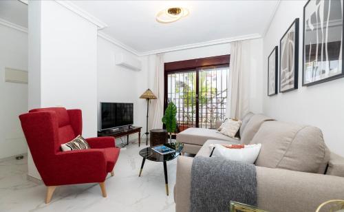 a living room with a couch and red chairs at Luxe Villa Puerto Banus in Marbella