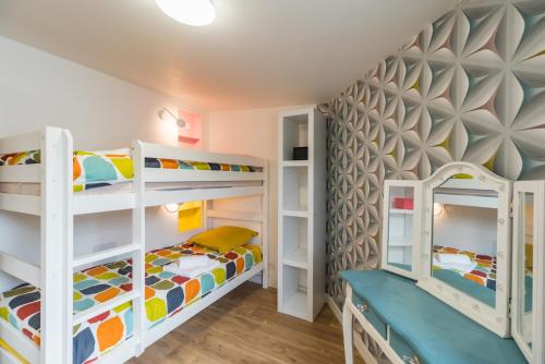 a kids room with bunk beds and a wall mural at Ty Ker Embrun - Maison Vue Mer à 280m de la plage in Plougrescant