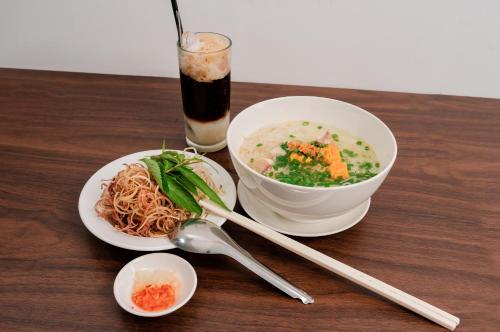 a table with a bowl of soup and a bowl of noodles at LÊ ĐOÀN HOTEL in Rạch Giá