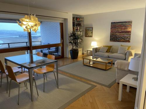 a living room with a dining room table and a couch at Iturrain by smiling rentals in Hondarribia
