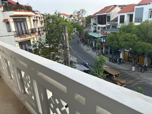 a view of a city street from a balcony at Vang Anh Homestay Hoi An in Hoi An