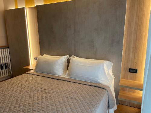 a bedroom with a bed with two white pillows at Hotel Villa Rosa in Sirmione
