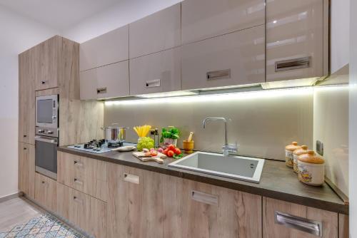 a kitchen with wooden cabinets and a sink in it at POSTU D'INCANTU in Sciacca
