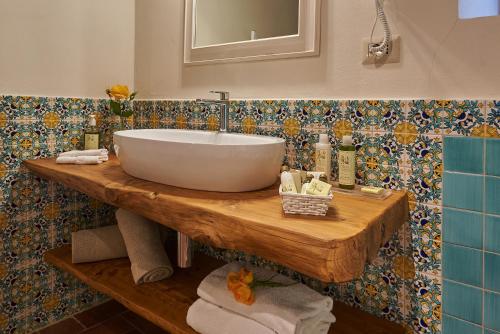 a bathroom with a large bowl sink on a wooden table at Hotel Belvedere Di San Leonino in Castellina in Chianti