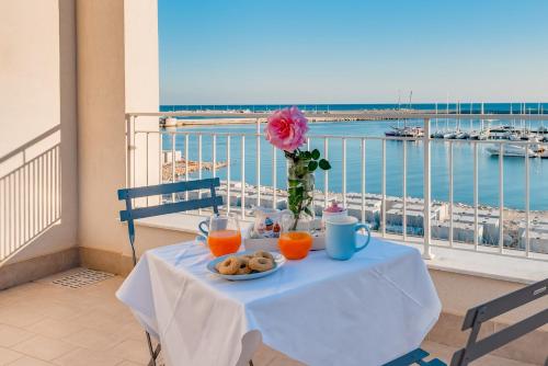 a table with a plate of food on a balcony at POSTU D'INCANTU in Sciacca