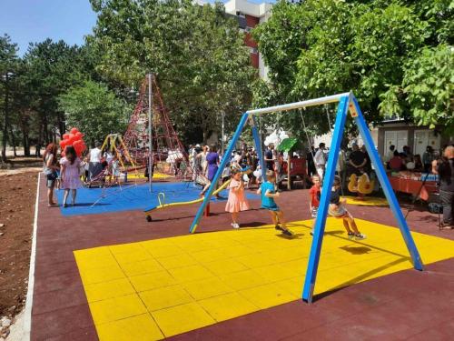 a group of children playing in a playground at Urban Studio Apartman in Trebinje