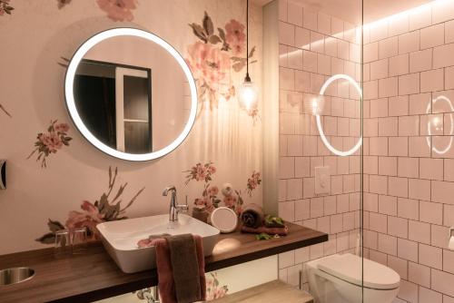 a bathroom with a sink and a mirror at Hotel / Weingut Meintzinger in Frickenhausen