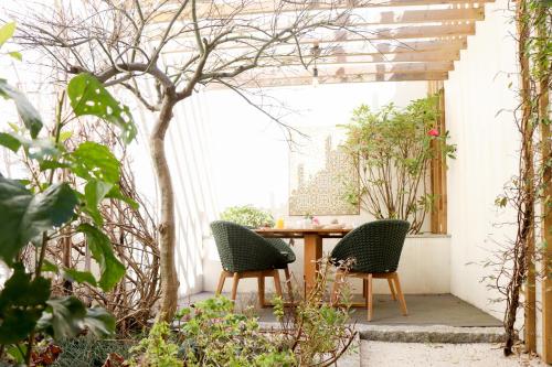 an outdoor patio with two chairs and a table at T'Luz in Porto
