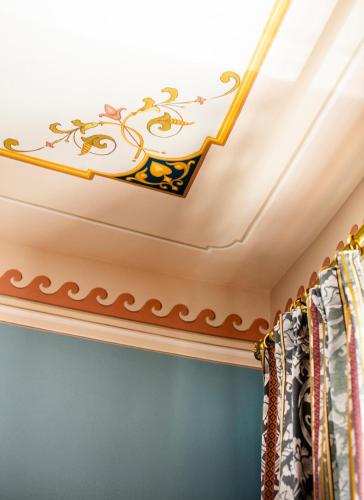 a room with a coffered ceiling with a gold trim at Palazzo Tiglio - A Small Luxury Hotels of the World in San Pancrazio