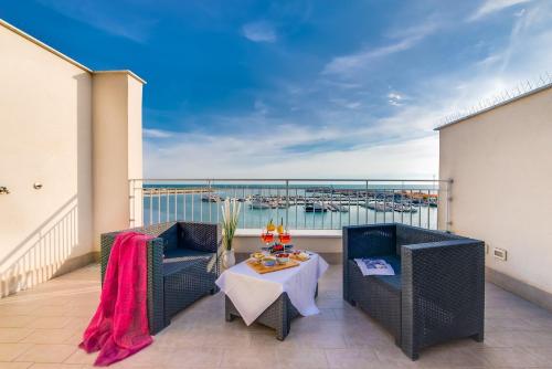 a balcony with two chairs and a table at POSTU D'INCANTU in Sciacca