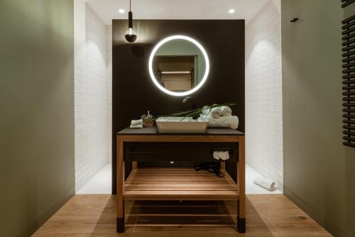 a bathroom with a sink and a mirror at Hotel / Weingut Meintzinger in Frickenhausen