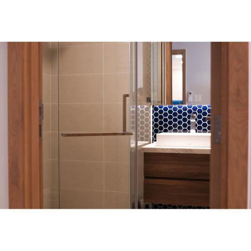 a bathroom with a shower and a sink and a mirror at Aria Vũng Tàu - 2WC 2PN view biển riêng - 128m2 in Xa Thang Nhut