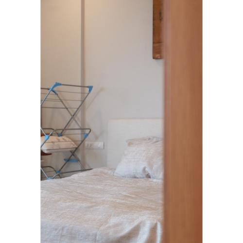 a bedroom with a white bed and a shelf at Aria Vũng Tàu - 2WC 2PN view biển riêng - 128m2 in Xa Thang Nhut