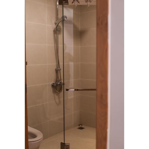 a shower stall with a toilet in a bathroom at Aria Vũng Tàu - 2WC 2PN view biển riêng - 128m2 in Xa Thang Nhut