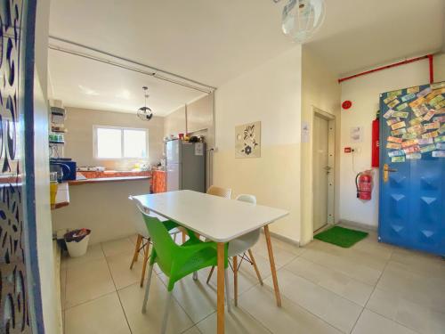 a kitchen with a table and chairs and a refrigerator at The Castle Star in Amman