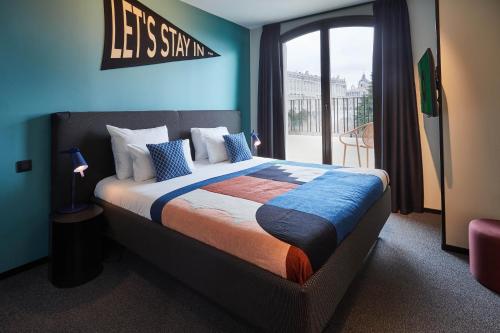 a bedroom with a bed with a sign that says lets stay in at The Social Hub Madrid 4 star in Madrid
