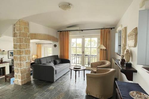 a living room with a couch and a table at TΟRRE DI PIETRA-LUXURY RESIDENCE-ΑMAZING SEA VIEW in Marathón