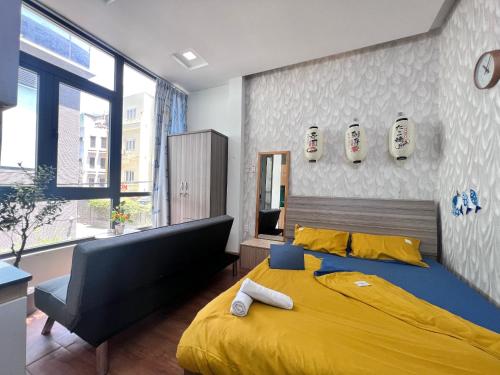 a bedroom with a large bed with a yellow blanket at Unique Studio in Japanese Town R102 -Central Saigon in Ho Chi Minh City