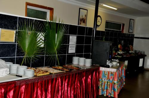 a buffet with plates and pastries on a table at Aybel İnn Hotel in Beldibi