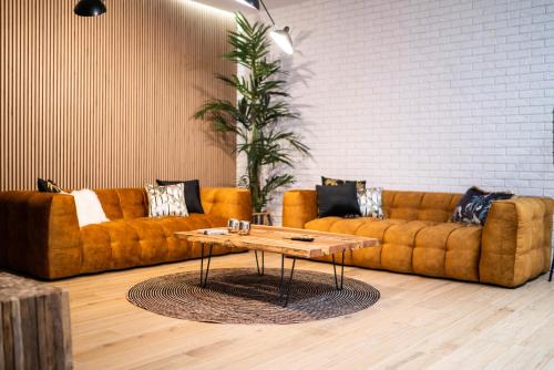 a living room with two couches and a coffee table at Mały Bór in Lgiń