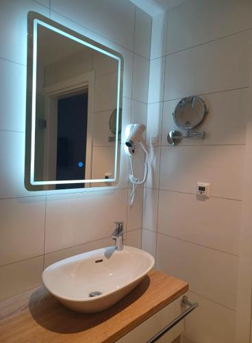 a bathroom with a sink and a mirror at Šangulin Palace M in Biograd na Moru