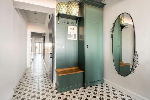 a hallway with a green door and a mirror at SVM suites With a sea view in nişantaşı in Istanbul