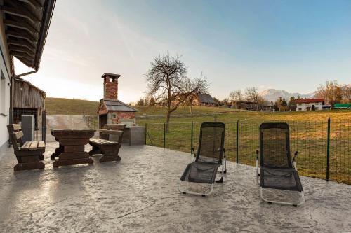 a patio with two lawn chairs and a grill at Apartments Linda in Brezje