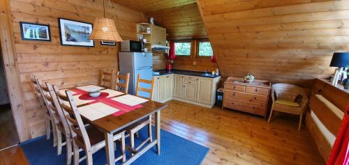 a kitchen with a dining table in a cabin at Radhošťský rybník in Trojanovice