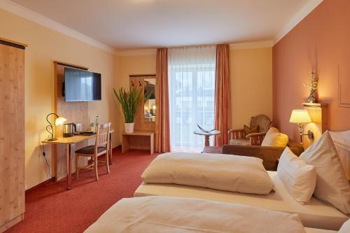 um quarto de hotel com duas camas e uma secretária em Hotel Gasthof Fellner em Furth im Wald