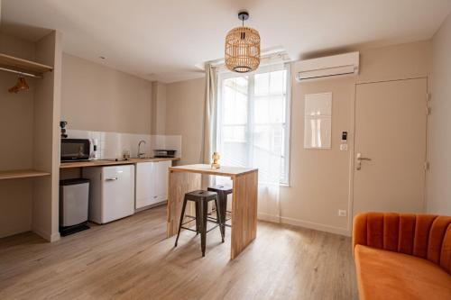 a kitchen with a table and chairs in a room at LE COURSARLON in Bourges