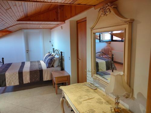 a bedroom with a mirror and a bed and a table at Vesta in Thessaloniki