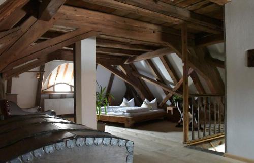an attic room with a bed and a couch at Ferienhaus Ickelhaus 1 in Bad Windsheim