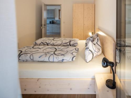 a bedroom with a bed and a mirror at Vintlerhof in Bressanone