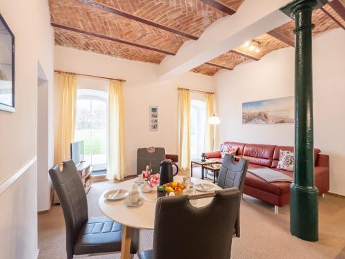 a living room with a table and a couch at Gut Vorwerk in Sagard