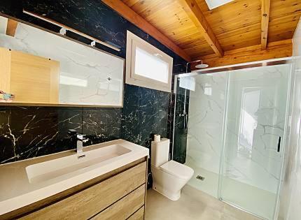 a bathroom with a toilet and a sink and a shower at Mar i Cel -Chalet con piscina privada- in Peniscola