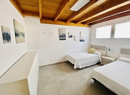 a white room with two beds and two windows at Mar i Cel -Chalet con piscina privada- in Peniscola