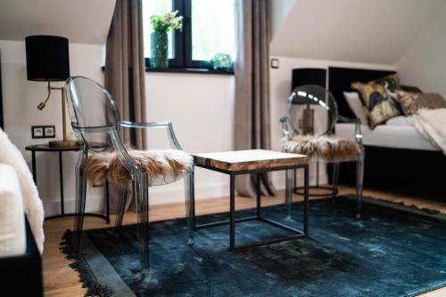 a living room with two chairs and a bed at Mały Bór in Lgiń