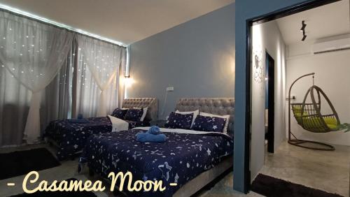 a bedroom with two beds with a blue pillow on it at Casamea MOON (Shoplot) 2 Bedroom-Free Wifi & Washer in Sibu