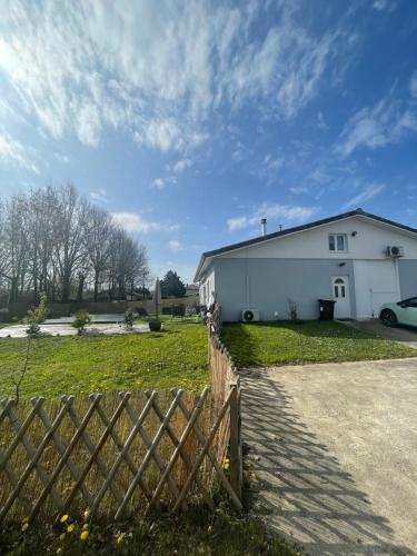 a white house with a fence in front of it at Cocooning chez Sabine in La Ville Dieu du  Temple