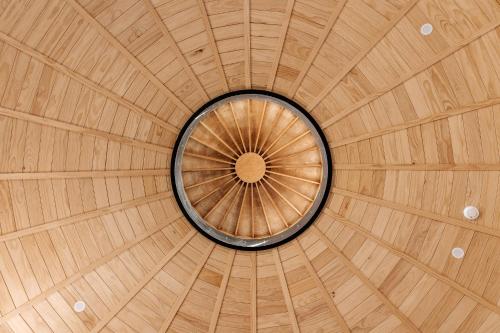 a wooden ceiling with a circle in the middle at Kaho - Ohakune Holiday Home with Spa in Ohakune